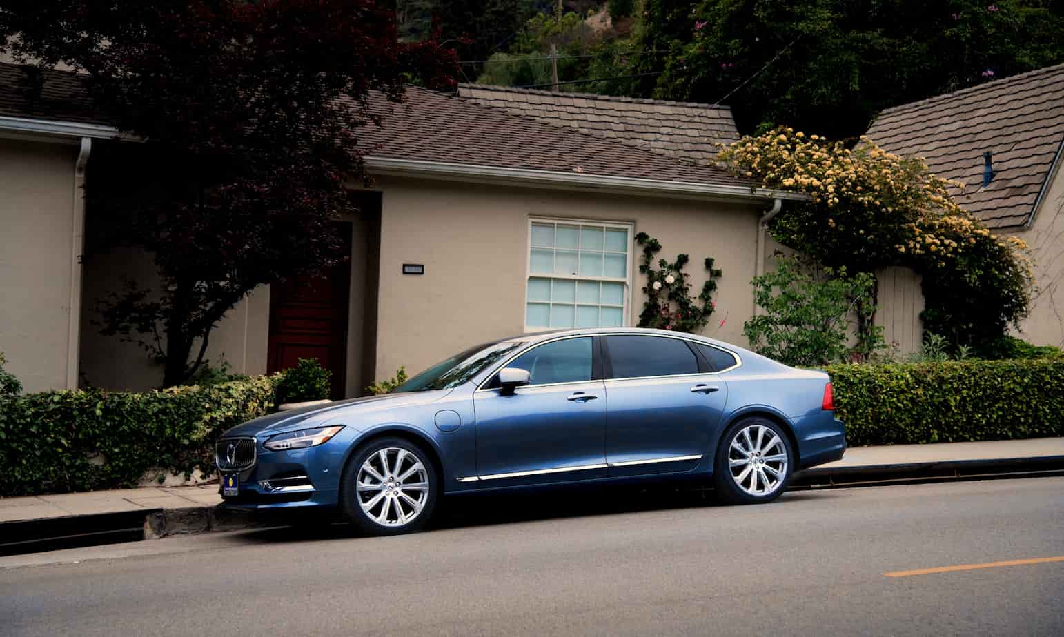 A modern sedan parked safely in a clean suburban driveway representing security and protection